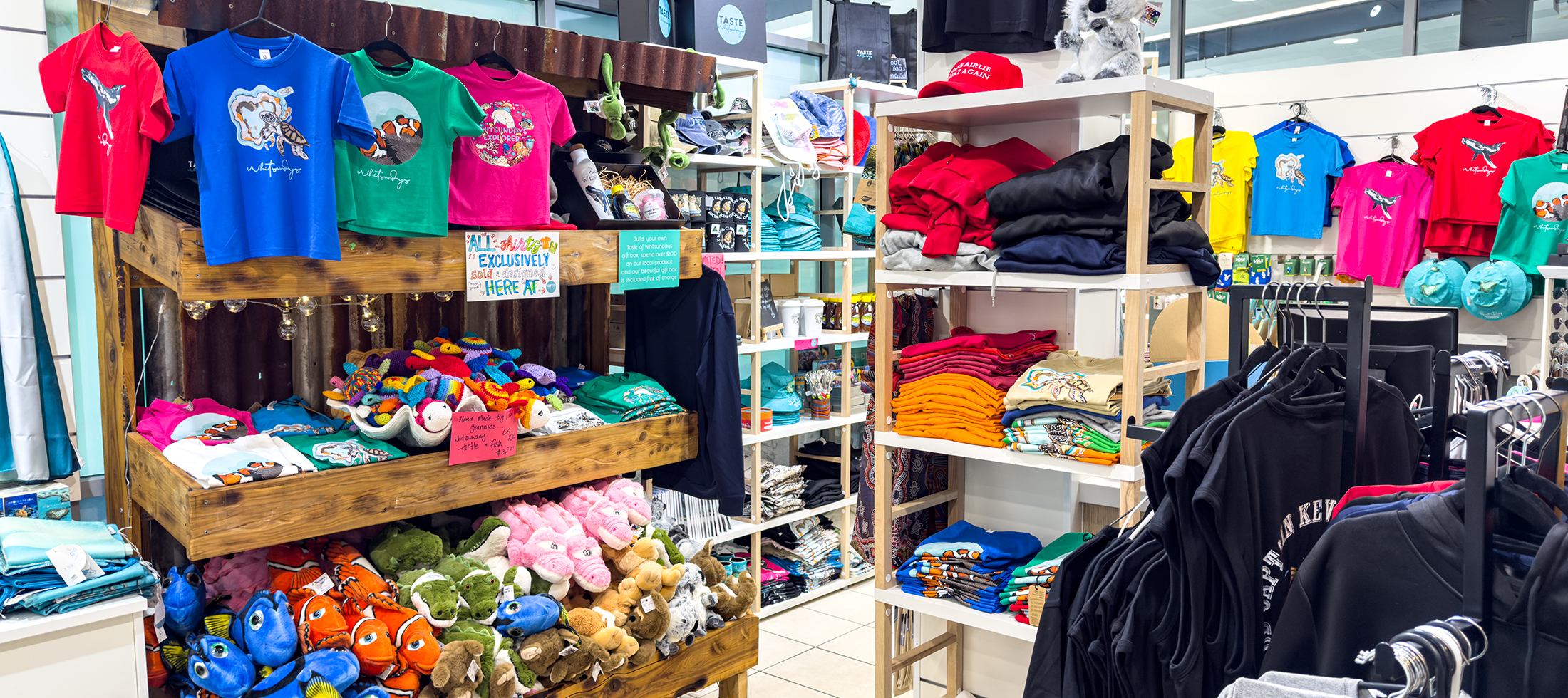 Store interior with shelves displaying various clothing and merchandise.