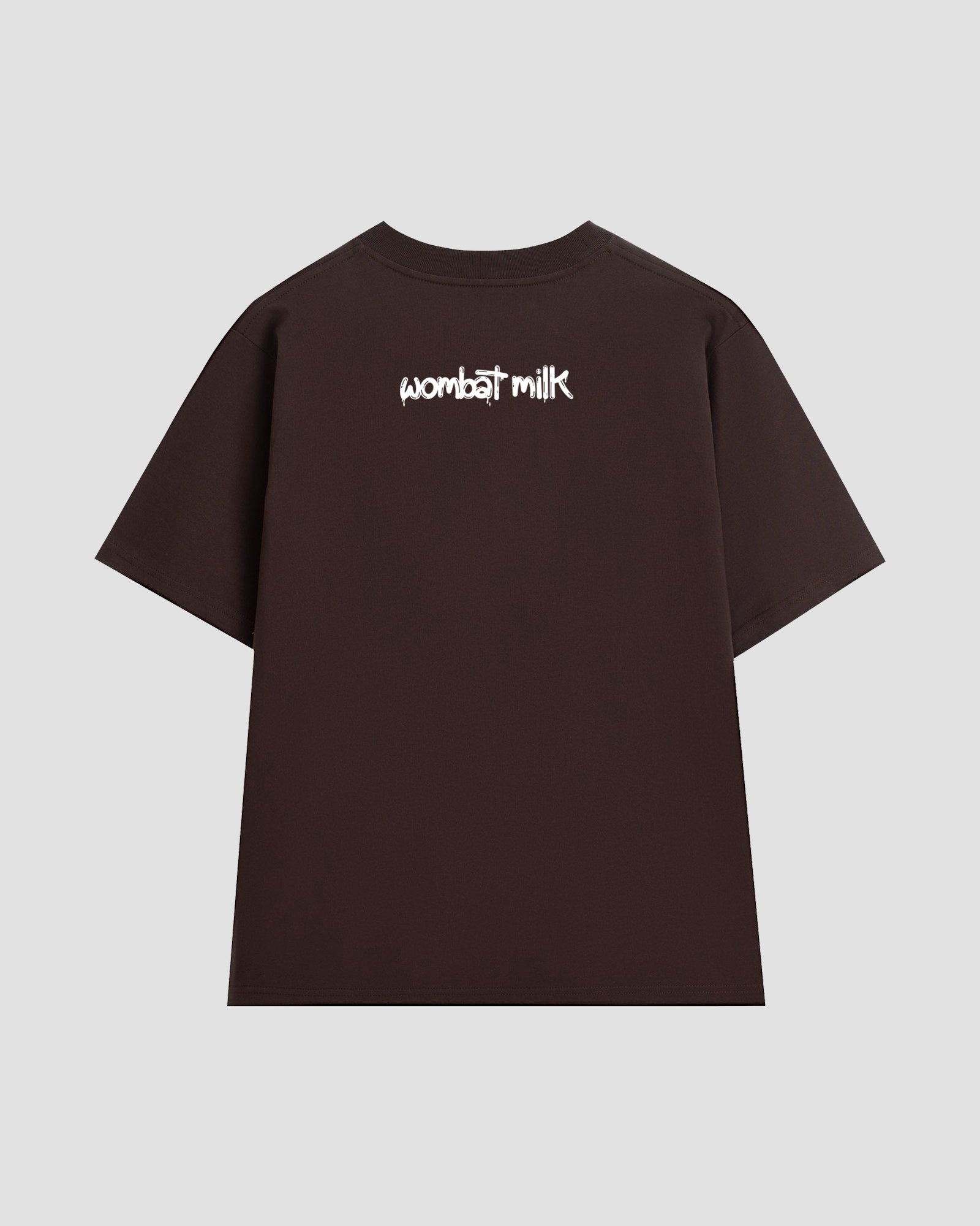 Brown t-shirt with 'wombat milk' text against a light grey background.
