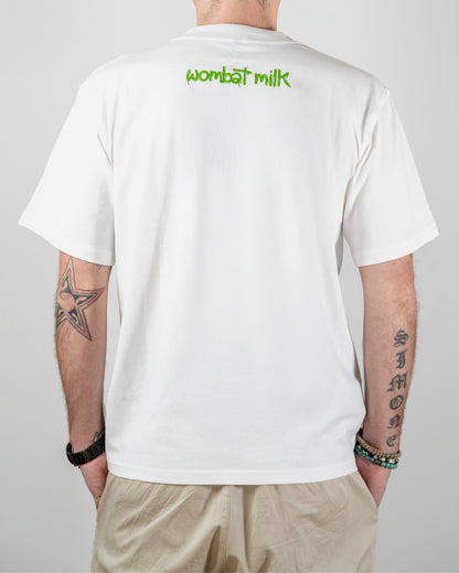 Person wearing a white t-shirt with 'wombat milk' text on the back, standing against a plain background.