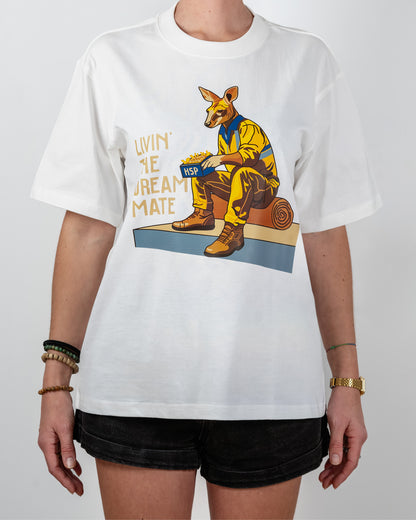 White t-shirt with a graphic design of a kangaroo wearing boots and a hat, sitting on a wooden log with the wording "livin' the dream mate".