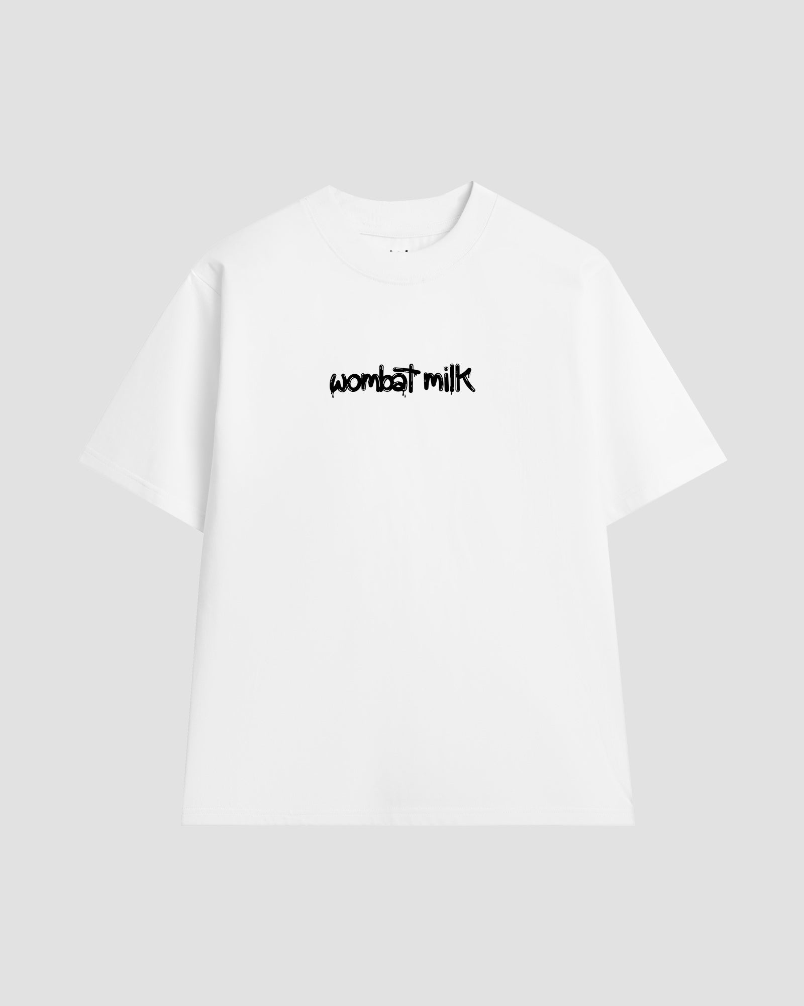 White unisex t-shirt featuring a black 'Wombat Milk' logo graphic centred on the chest.